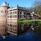 Rozendaal castle with Donjon from 1314 and 2,5 -4,0 m thick walls mirrored in the pond end februari 2011 on a sunny day
